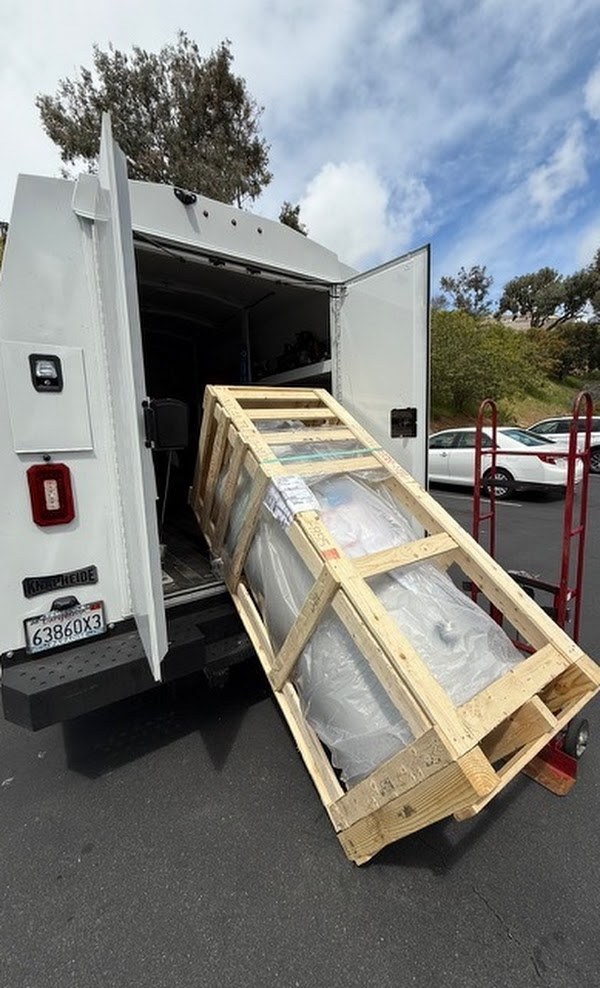 Water heater being unloaded from a service van for replacement