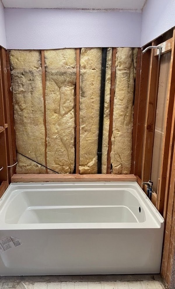 New bathtub set during a bathroom plumbing renovation