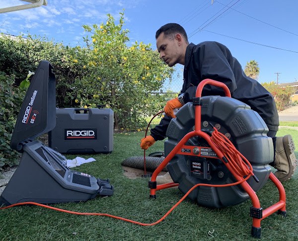 Spartan Plumbing technician inspecting a line with a RIDGID SeeSnake camera